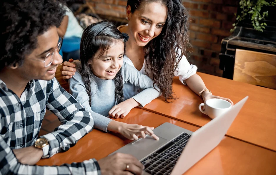 A happy family having fun together at a laptop