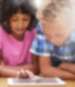 Girl and Boy learning with AI on an Ipad.