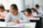 Eye-level view of a classroom with students engaged in group discussion